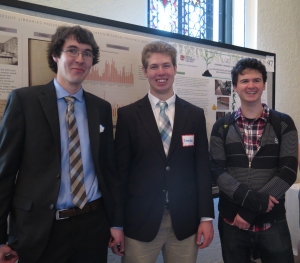 Dan Snow and Brendan Courtois (and fellow Ramonat Scholar Andrew Kelly) in front of the poster on their work analyzing the book trade ledger.